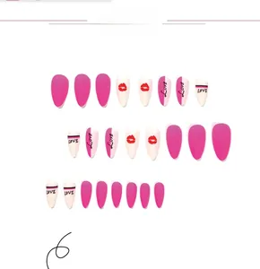 Close-up of matte pink and white press-on nails with love letters and red lip prints
