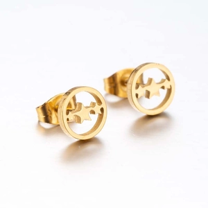 Detail of golden hollow star inside circle stud earrings with metallic finish