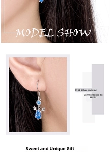 Detailed close-up of S999 sterling silver reindeer antler earrings with blue teardrop stones