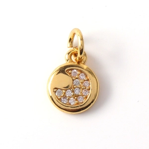Detailed view of a gold round sun and moon pendant with shimmering inlaid zircon stones
