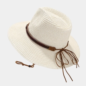 Western straw cowboy hat with ethnic feather band and adjustable chin strap