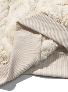 Detailed close-up of cream fleece fabric and ribbed knit cuffs on men hoodie