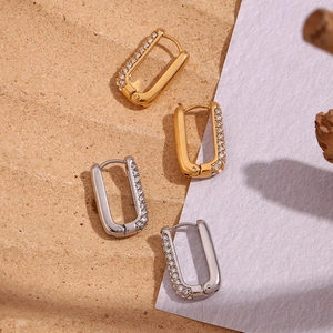 Detailed view of 18K gold and silver rectangular huggie earrings with micro zircon stones