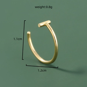 Macro shot of U-shaped golden nose ring with dimensions 1.1x1.2cm and 0.8g weight