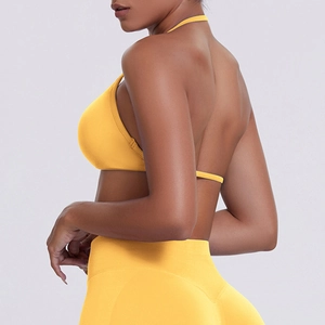 Detail of high-stretch bright yellow sports bra and leggings set with ribbed texture