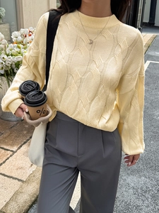 Chic beige cable knit sweater with long sleeves and crew neck in a relaxed fit style