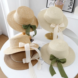Elegant flat top straw boater hats with pearl trim and ribbon bows for beach vacation