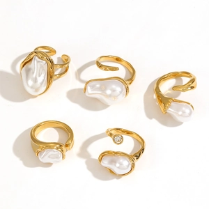 Baroque pearl ring set in gold stainless steel with adjustable open design on white background