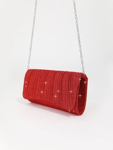 Macro shot of red glitter wedding clutch bag with elegant silver metal chain strap
