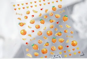 Macro detail of ultra-thin orange fruit nail stickers with vibrant citrus and heart patterns