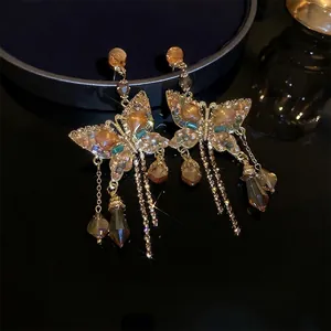 Bohemian crystal butterfly fringe earrings with brown crystals and golden tassels