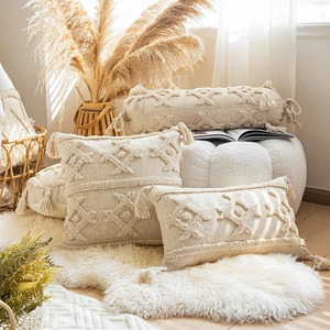 Bohemian beige tufted pillow cover with geometric diamond patterns and fringe accents
