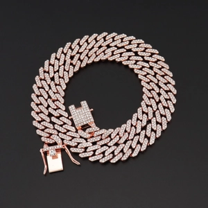 Macro detail of rose gold Cuban link chain with paved diamonds on a black background
