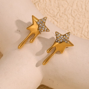 Macro shot of 18K gold plated star earrings with liquid metal flow design and zircon
