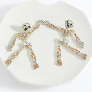 Detailed view of articulated skeleton earrings with gold finish and colorful rhinestones