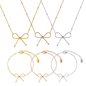 Elegant gold, silver, and rose gold bow necklace and bracelet sets for women on white background