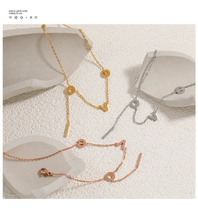 Macro detail of LOVE letter charms and bar pendants in gold, silver and rose gold finishes