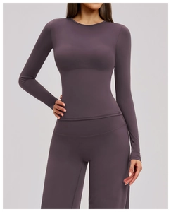 Detail of long sleeve brushed yoga top and high waist flared pants in mauve purple