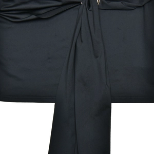 Detail shot of the twist knot waist design on a black long-sleeve bodycon dress