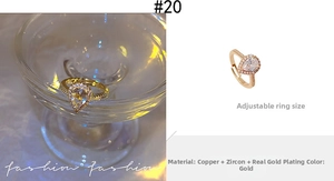 Close-up of a pear-shaped zircon ring with gold plating and adjustable open band