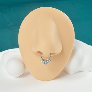 Close-up of fan-shaped silver septum ring with opalescent stones on a nose model