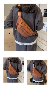 Detailed views of a brown woven texture chest bag showing the weave and strap buckle