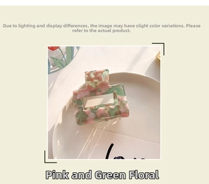 Detail view of square floral acetate hair claw with pink and green marble pattern texture