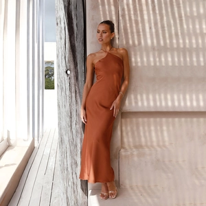 Detail of elegant backless halter dress in rust red satin with high-gloss finish