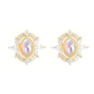 Detailed macro of gold vintage earrings with marquise stones and opal-style centers