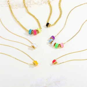 Golden chain necklaces featuring colorful enamel star beads in various vibrant shades