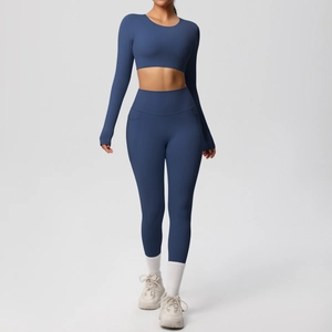 Detail of navy blue high-waisted yoga leggings with functional side pockets and crop top