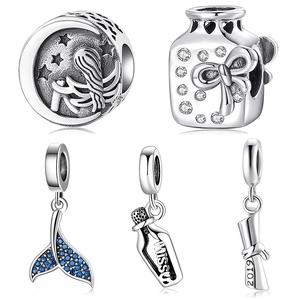 Detailed view of S925 sterling silver charms featuring moon, angel and graduation scroll