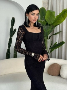 Detail of square neckline and sheer lace sleeves on a slim-fit black bodycon dress