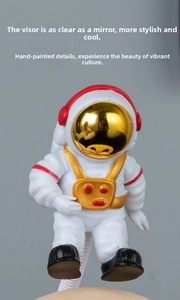 Detail of hand-painted astronaut figure with a reflective gold mirror visor and red accents