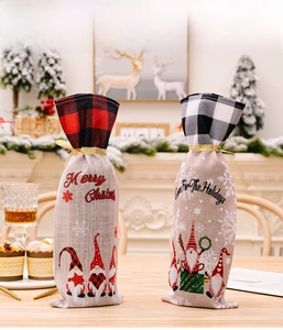 Close-up of Christmas gnome wine bottle bags with buffalo plaid trim and drawstring