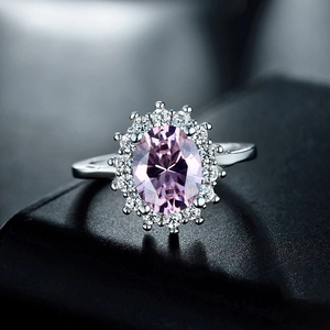 Luxurious 925 silver ring featuring a large oval pink stone with a floral halo of diamonds