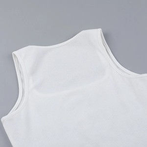 Detailed close-up showing the neck and armhole stitching on a white ribbed knit top