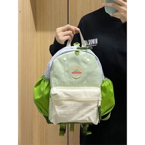 Detail view of lightweight student backpack with green color block design and side pockets