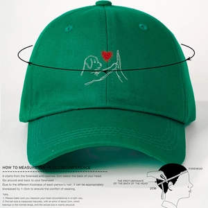 Green cotton baseball cap with puppy high-five embroidery and head size guide