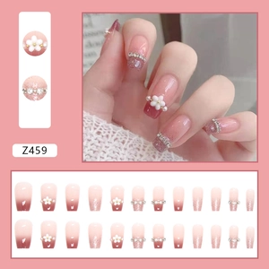 Pink gradient press-on nails with white flower charms and pearl chain accents set
