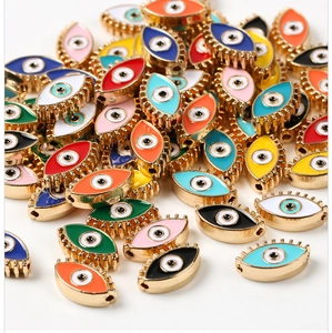 Macro shot of colorful enamel evil eye charm beads with gold trim for DIY jewelry making