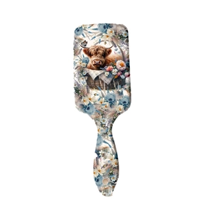Western highland cow with floral basket print on a professional air cushion hairbrush
