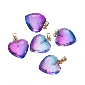 Detailed view of purple-blue gradient heart pendants with gold clasps for jewelry DIY