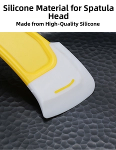 Close-up detail of flexible silicone kitchen spatula head with dual-color design