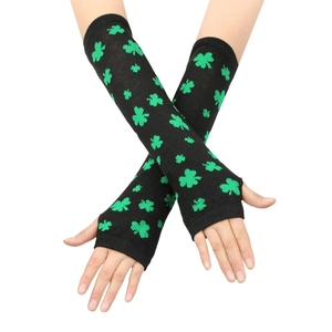 Close-up of black knit fingerless gloves with green shamrock pattern for St. Patrick's Day