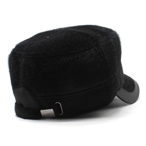 Detailed close-up of a black winter cadet hat featuring plush fur and a metal logo plate