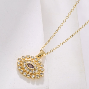 Gold evil eye pendant necklace with purple zircon stone and pavé crystal accents