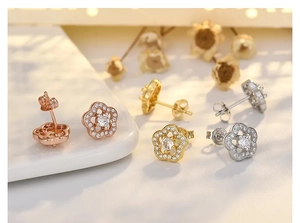 Close-up of flower shaped zircon studs in rose gold, gold and silver finishes