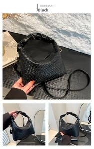 Detail view of black woven hobo handbag featuring a soft gathered handle and PU leather texture