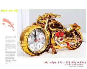 Detailed macro view of a vintage golden motorcycle desk clock with quartz movement dial